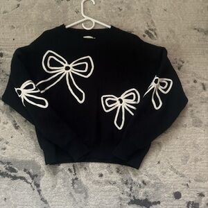 Elegant Black Sweater with White Bow Details